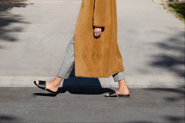 Woman wearing Gallito Shearling slide sandals in black