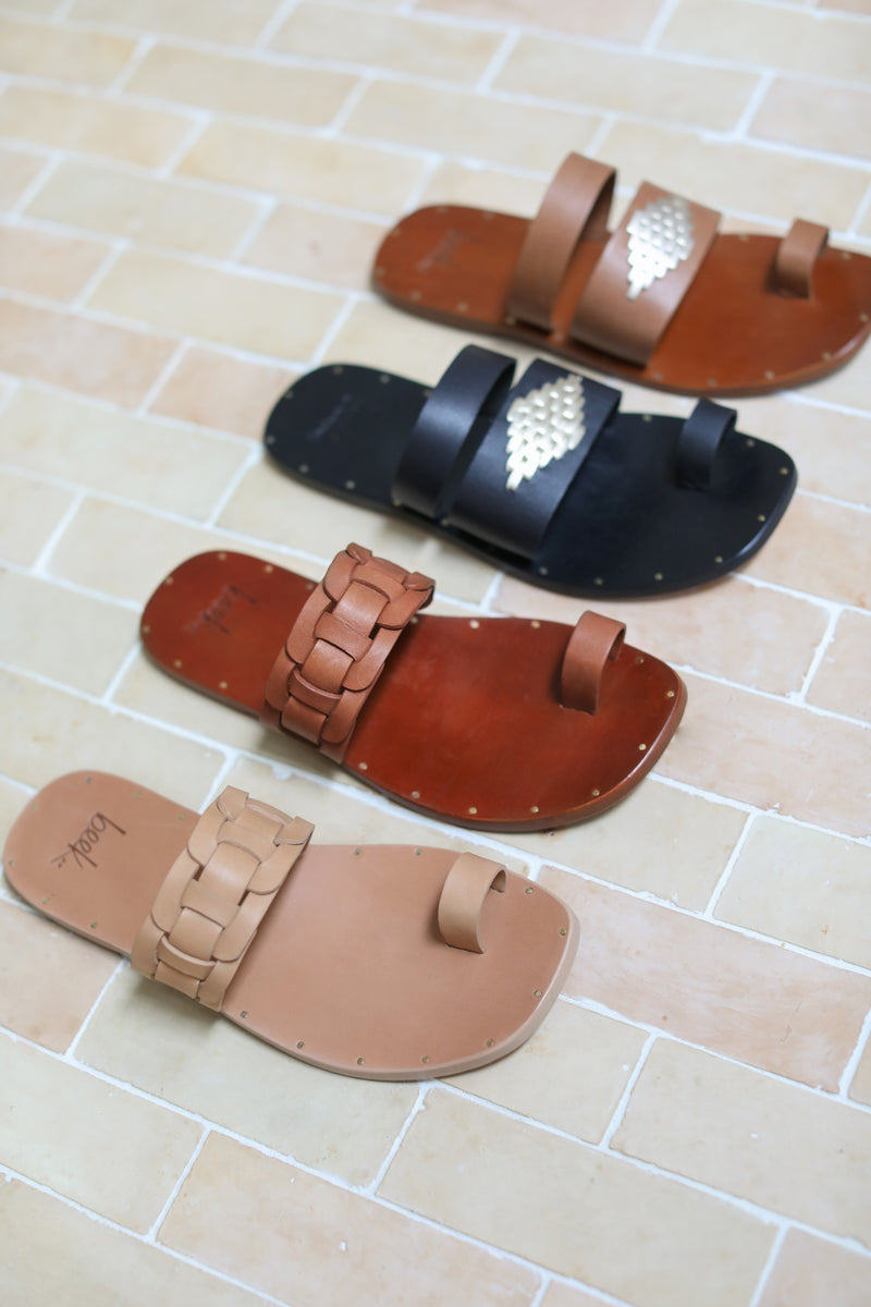 Barbet leather toe-ring sandals in honey and cognac with Brilliant leather toe-ring sandals in black and cognac.