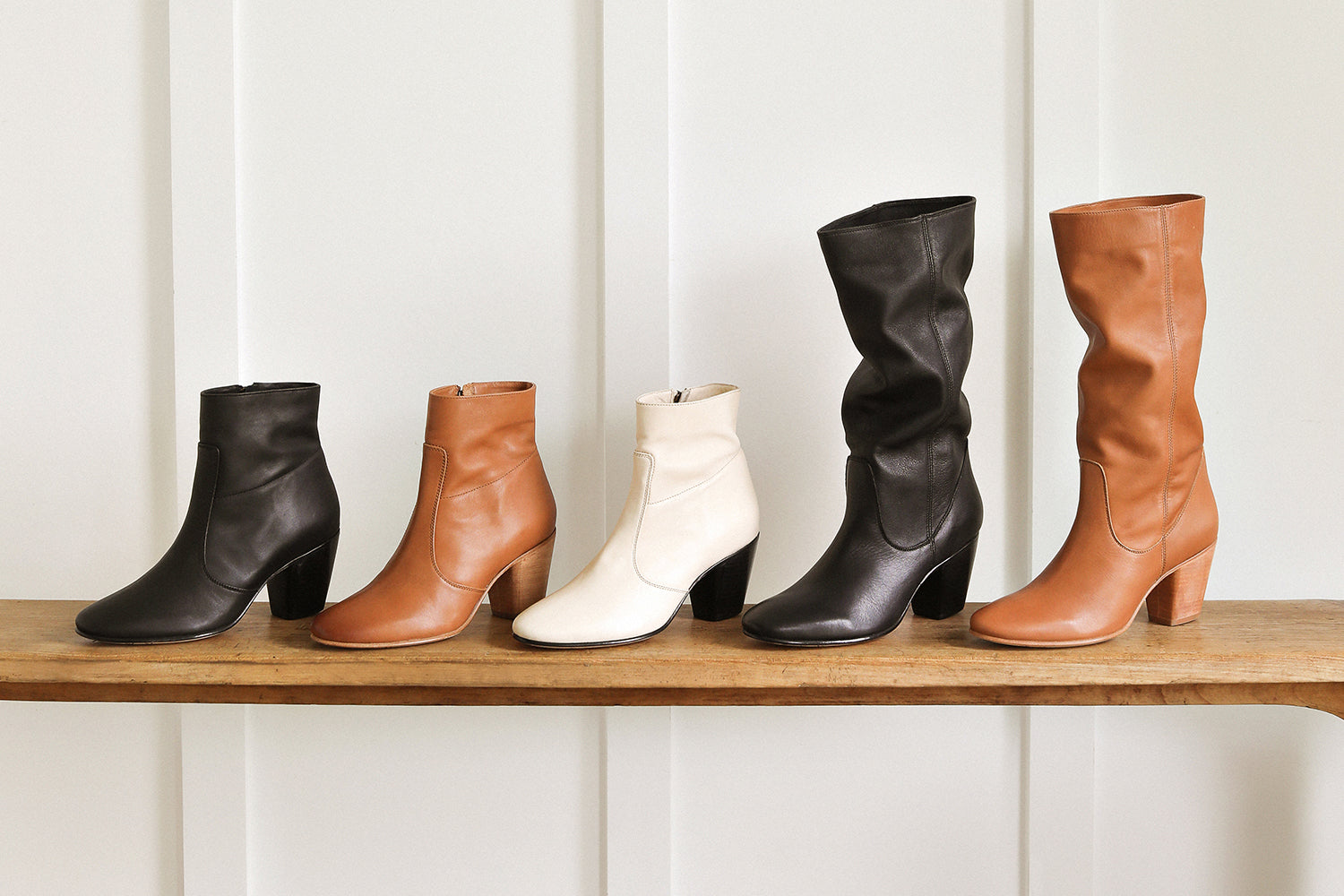 Group shot of Catbird leather boots in black, tan, eggshell with Crow tall leather boots in black and tan.