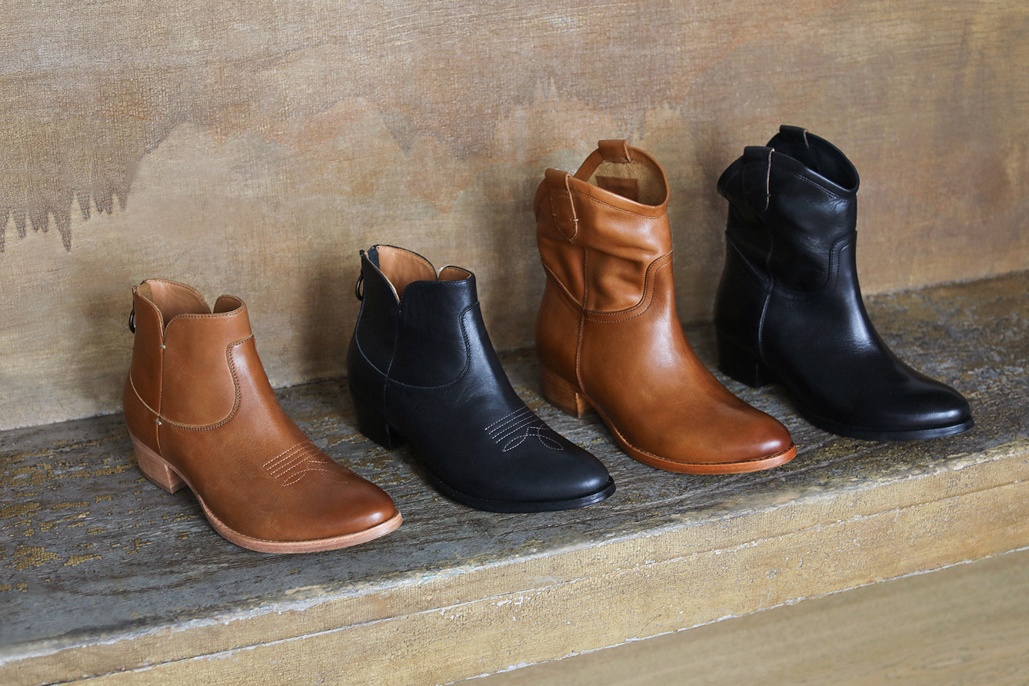 Group shot of Cowbird leather boots in tan and black with Condor leather boots in tan and black.