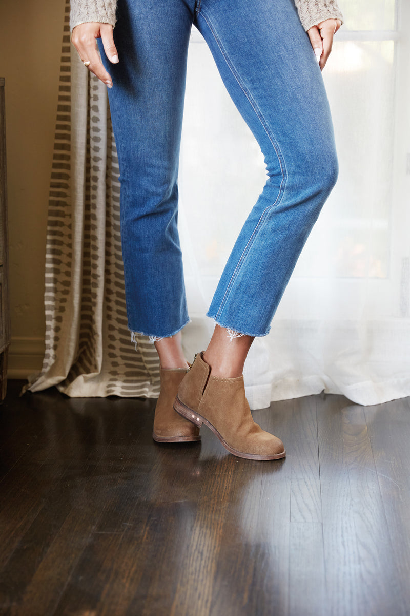 Woman wearing Falcon suede booties in chestnut with jeans and sweater.