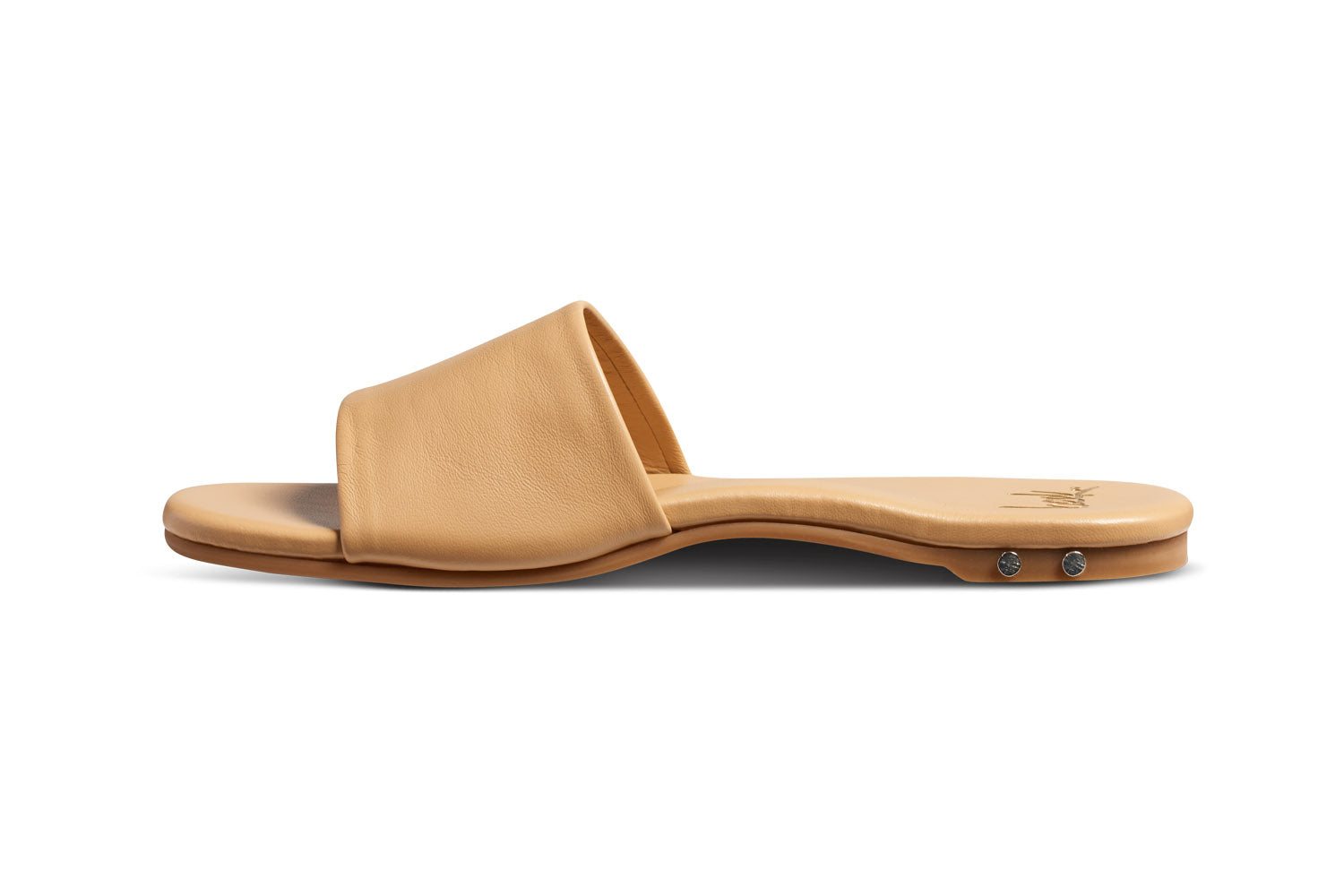 Honeybird leather slide sandals in beach - side shot