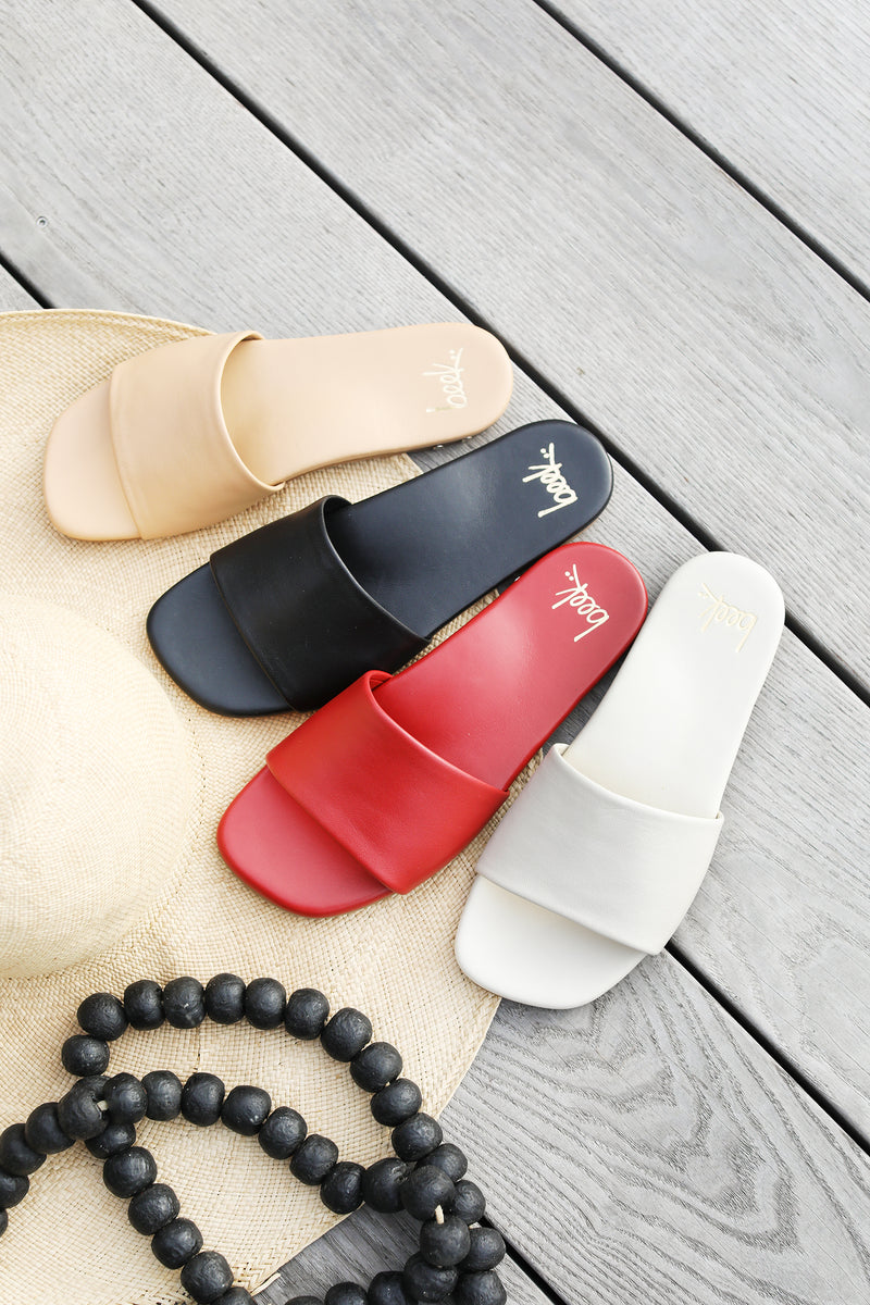 Honeybird leather slide sandals in beach, black, red, and eggshell