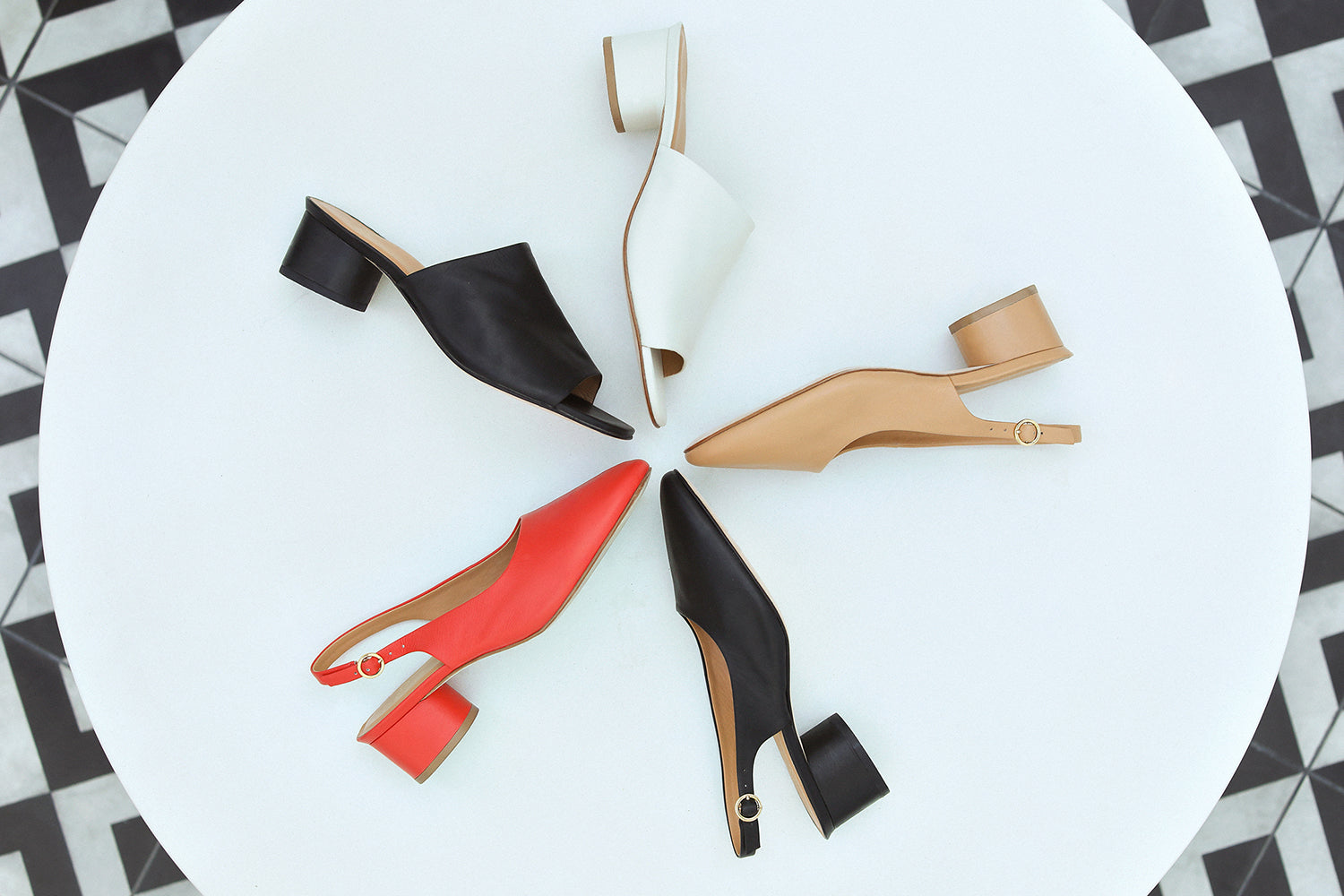 Group shot of Lora leather heeled mules in tomato, black, beach with Stilt in black and vanilla