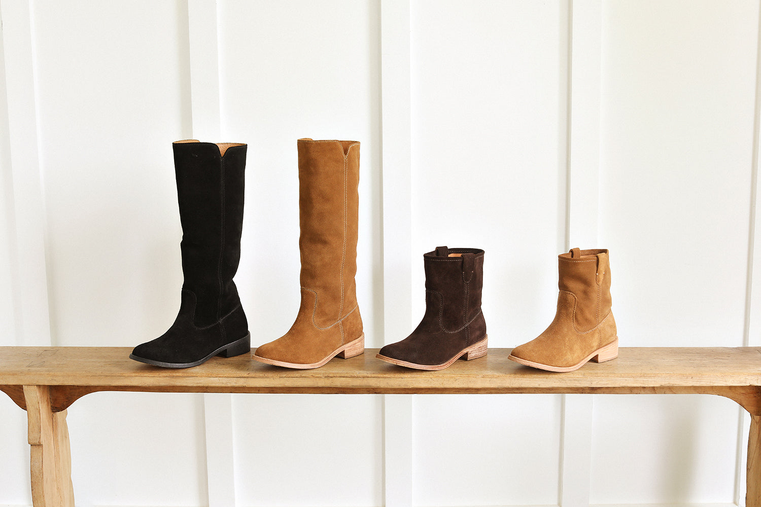 Group shot of Nuthatch suede knee-high boots in black and chestnut with Grouse slouchy suede boot in coffee and chestnut.