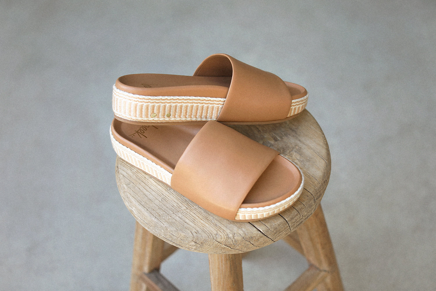 Pelican Textile wrapped leather platform sandal in honey on wooden stool