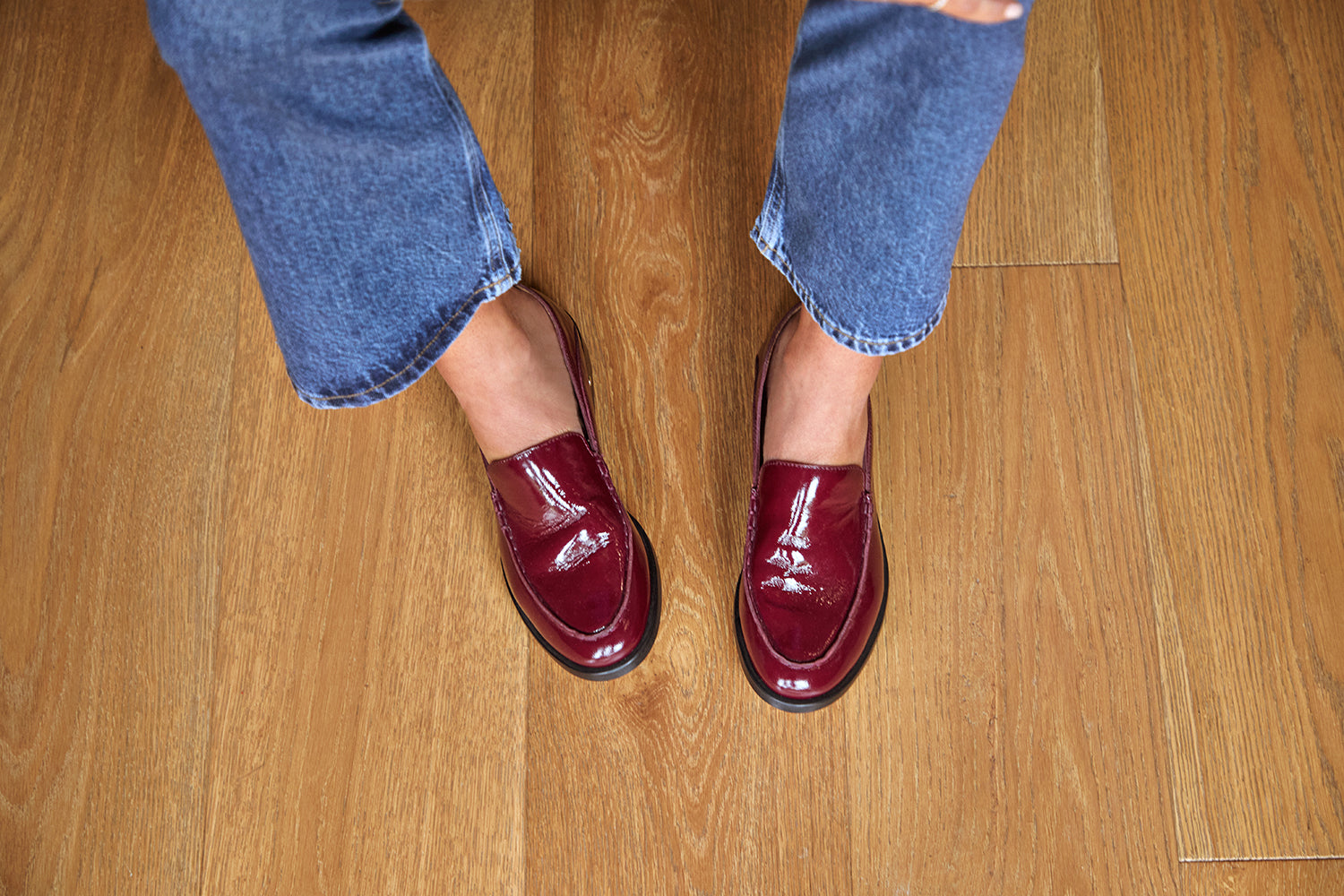 Woman wearing Pepper patent leather loafer in wine with jeans