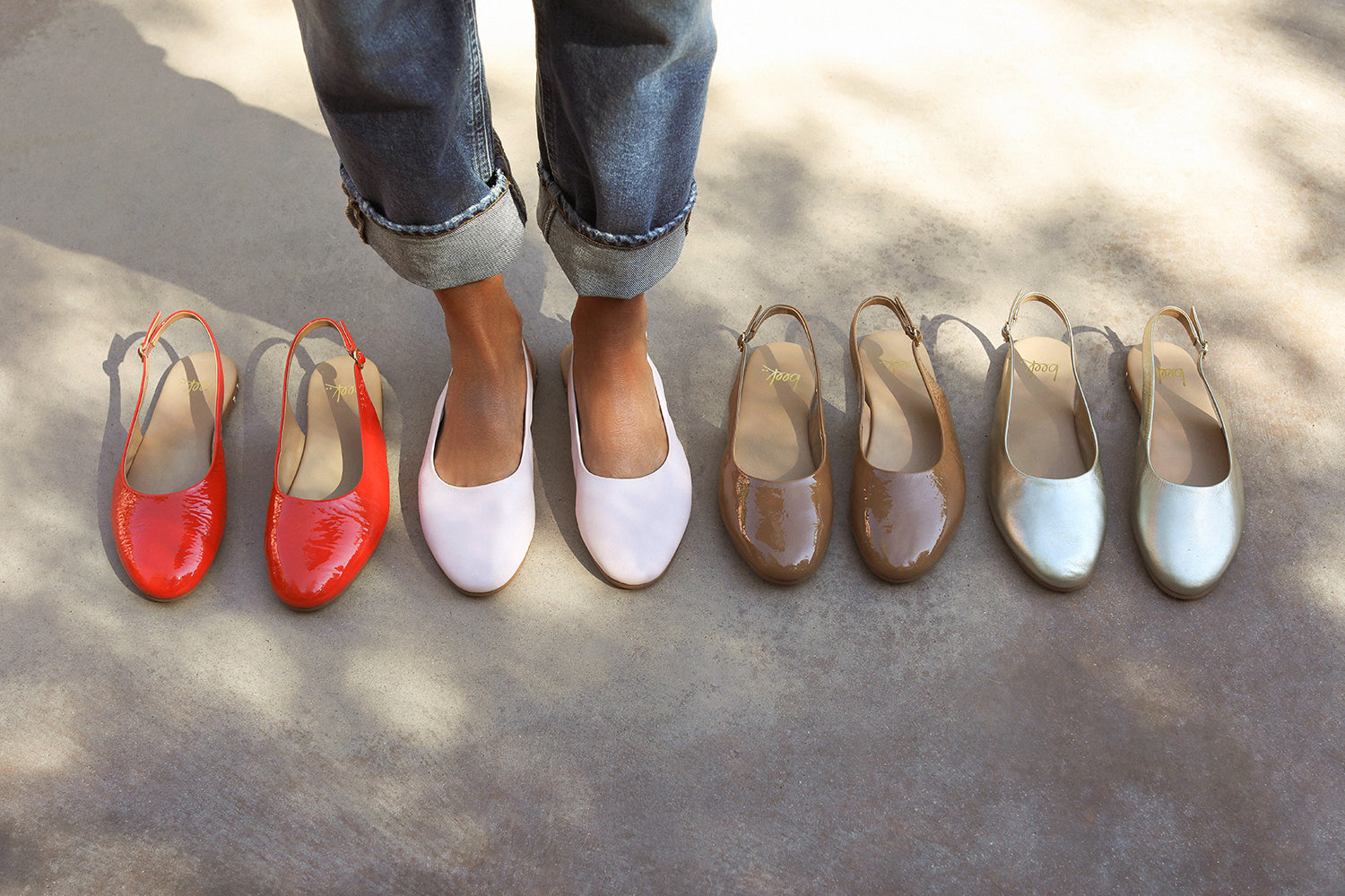 Woman wearing Pipit leather ballet mules in blossom next to Pipit in patent leather tomato, patent leather latte, and leather gold.