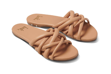 Puffback leather slide sandal in beach - angle shot