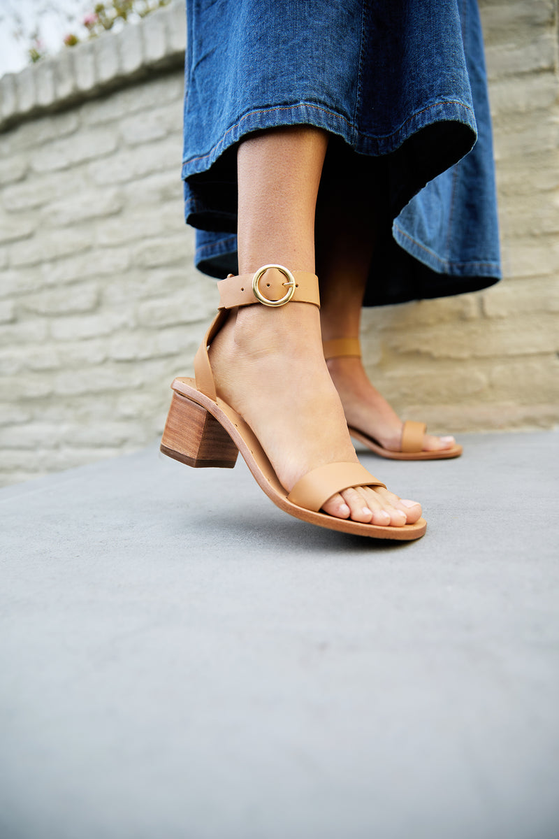 Woman wearing Sapphire block heel sandal in honey with denim dress
