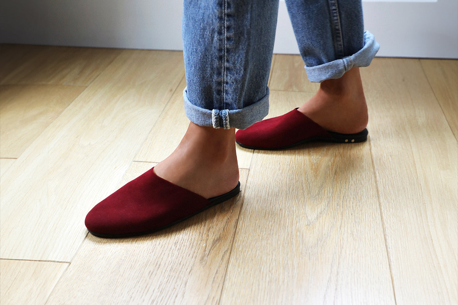 Woman wearing Siskin suede mule in port with jeans.