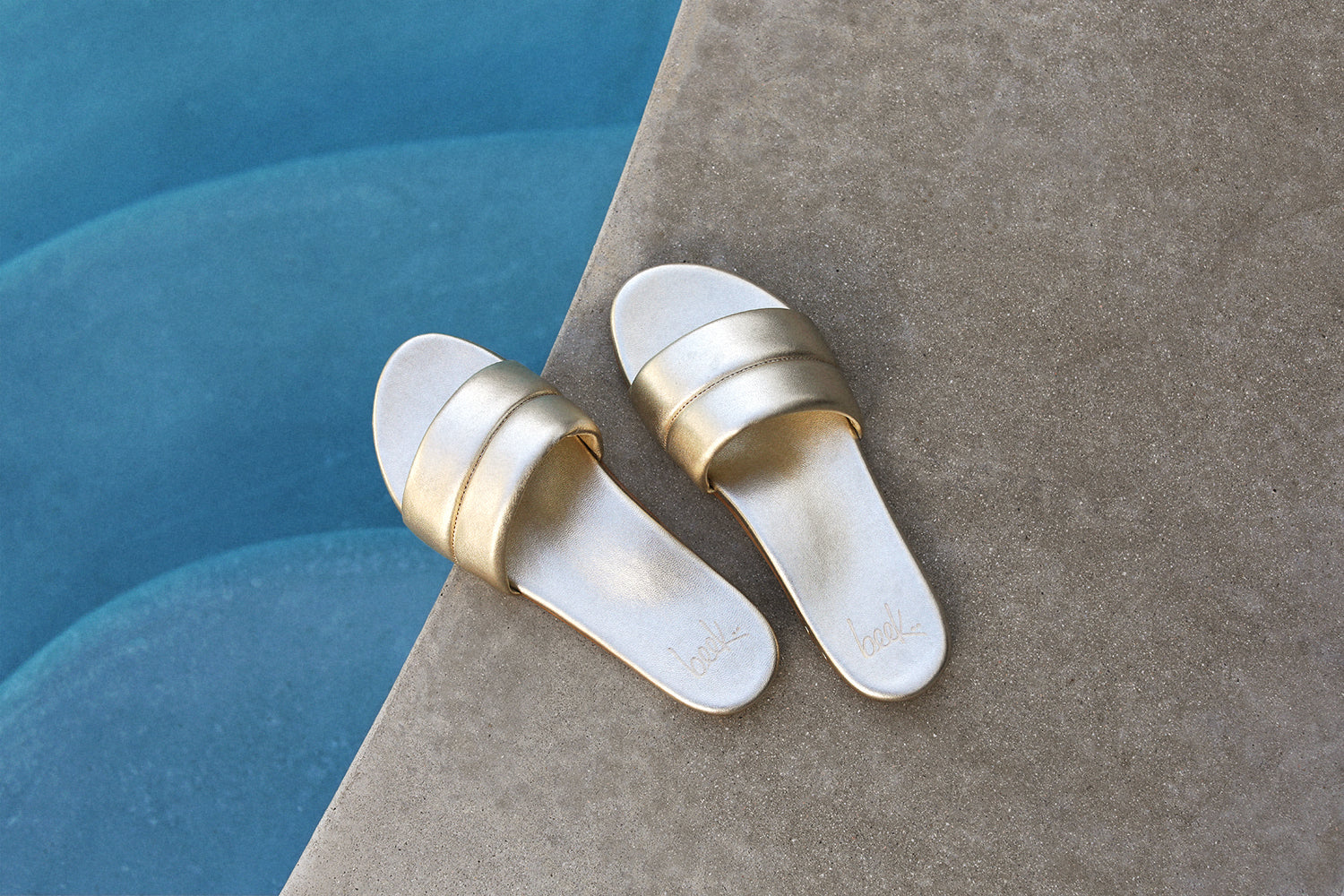 Sugarbird Leather Slide Sandal in platinum by the pool