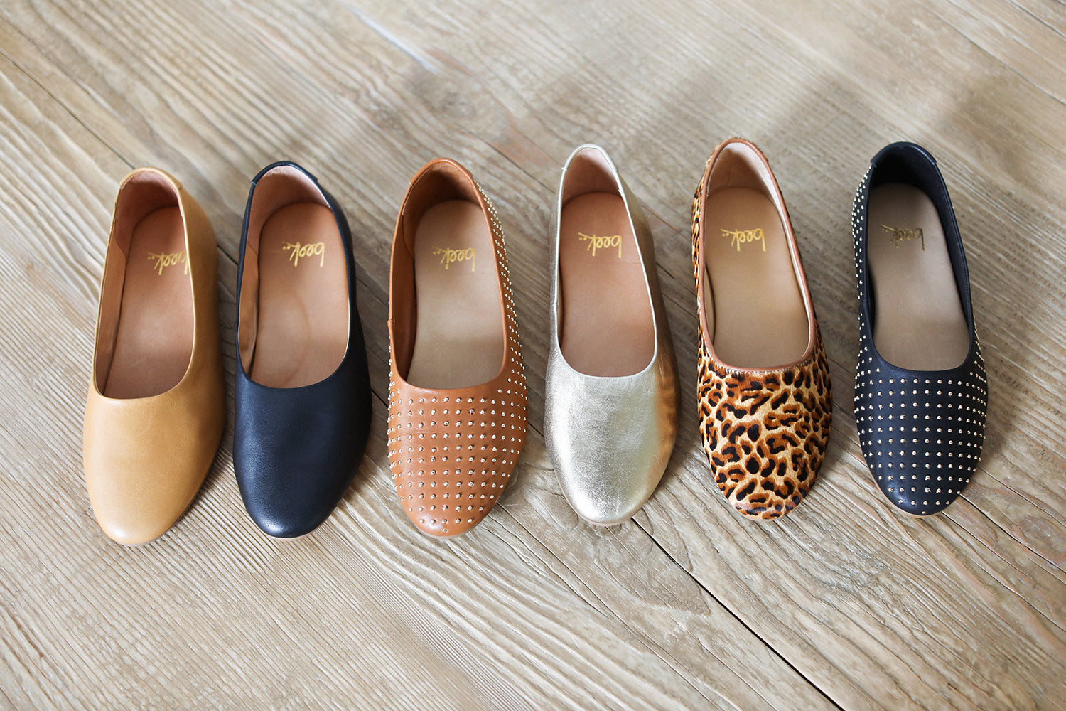 Group shot of Swiftlet ballet slippers in leather honey, leather black leather gold, calf-hair leopard with Swiftlet Stud ballet slippers in leather tan and leather black.