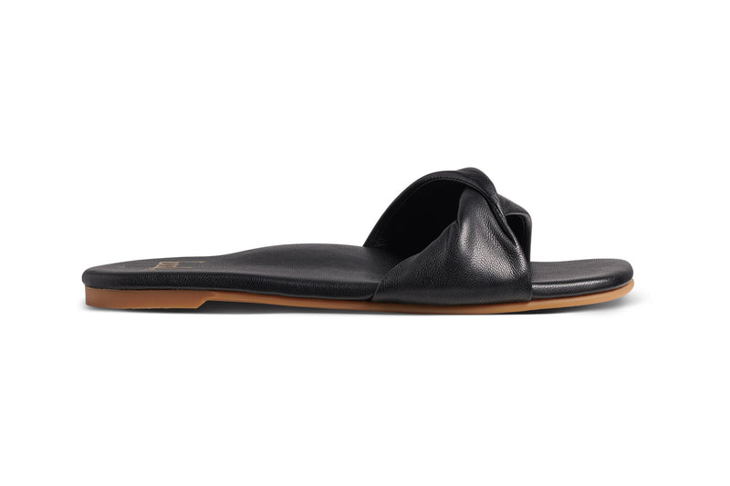Whipbird leather slide sandal in black - side shot