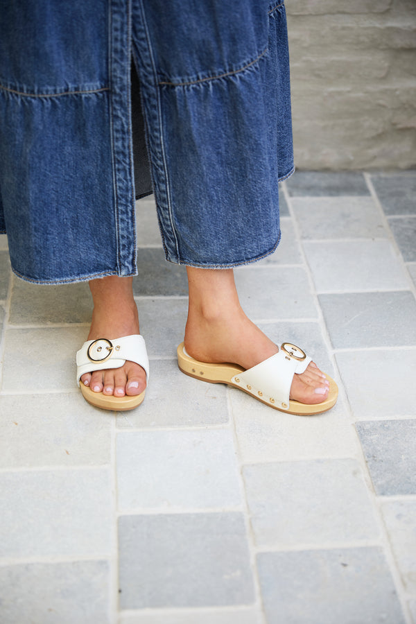 Woman wearing Woodstar clog sandal in vanilla with denim dress