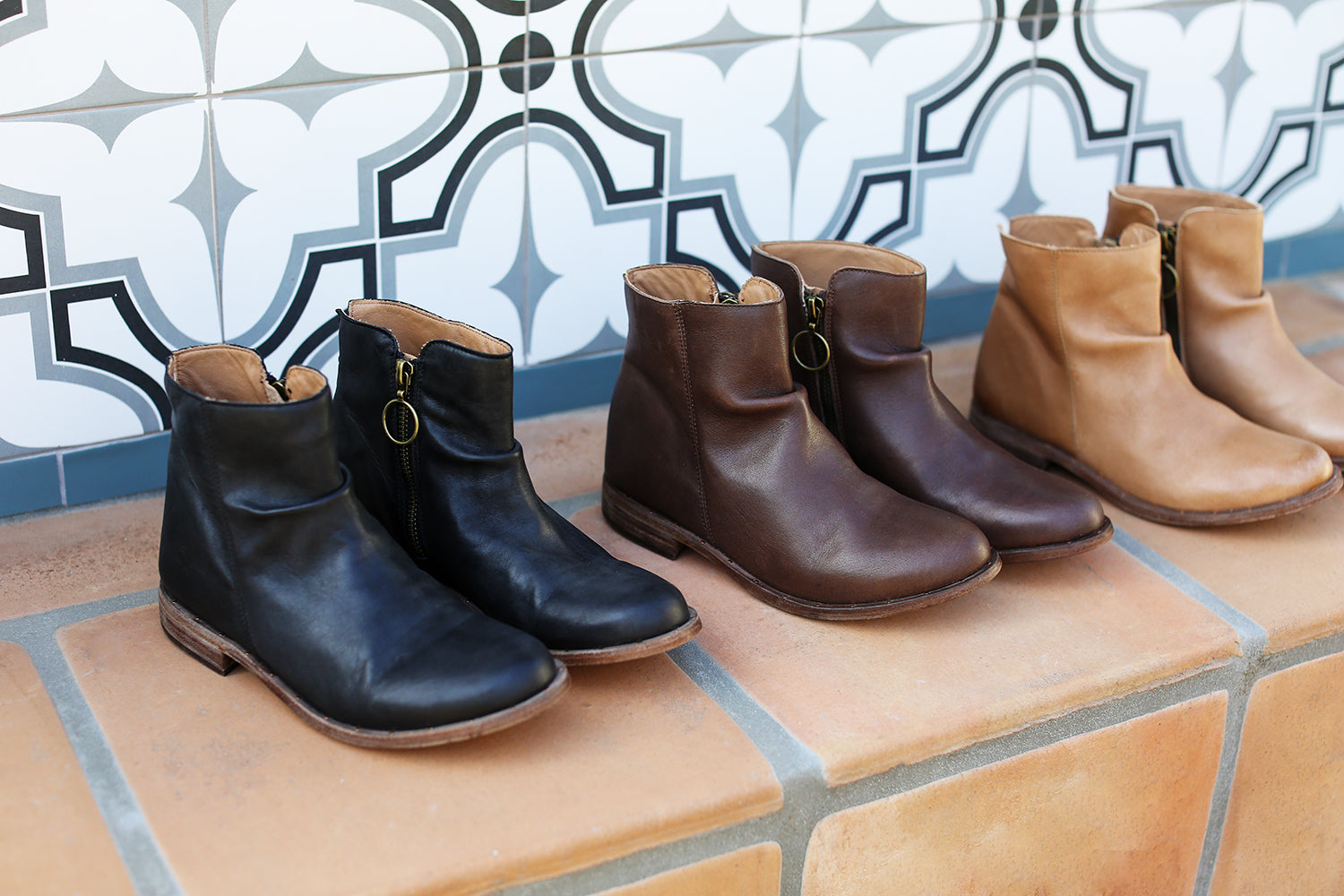 Group product shot of Quail leather ankle boots in black, chocolate, saddle