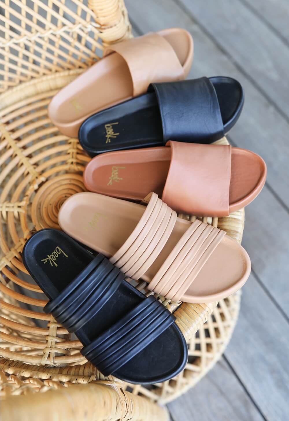 Group shot of Macaw leather strappy sandals in black and honey with Pelican platform sandals in tan, black, and honey.