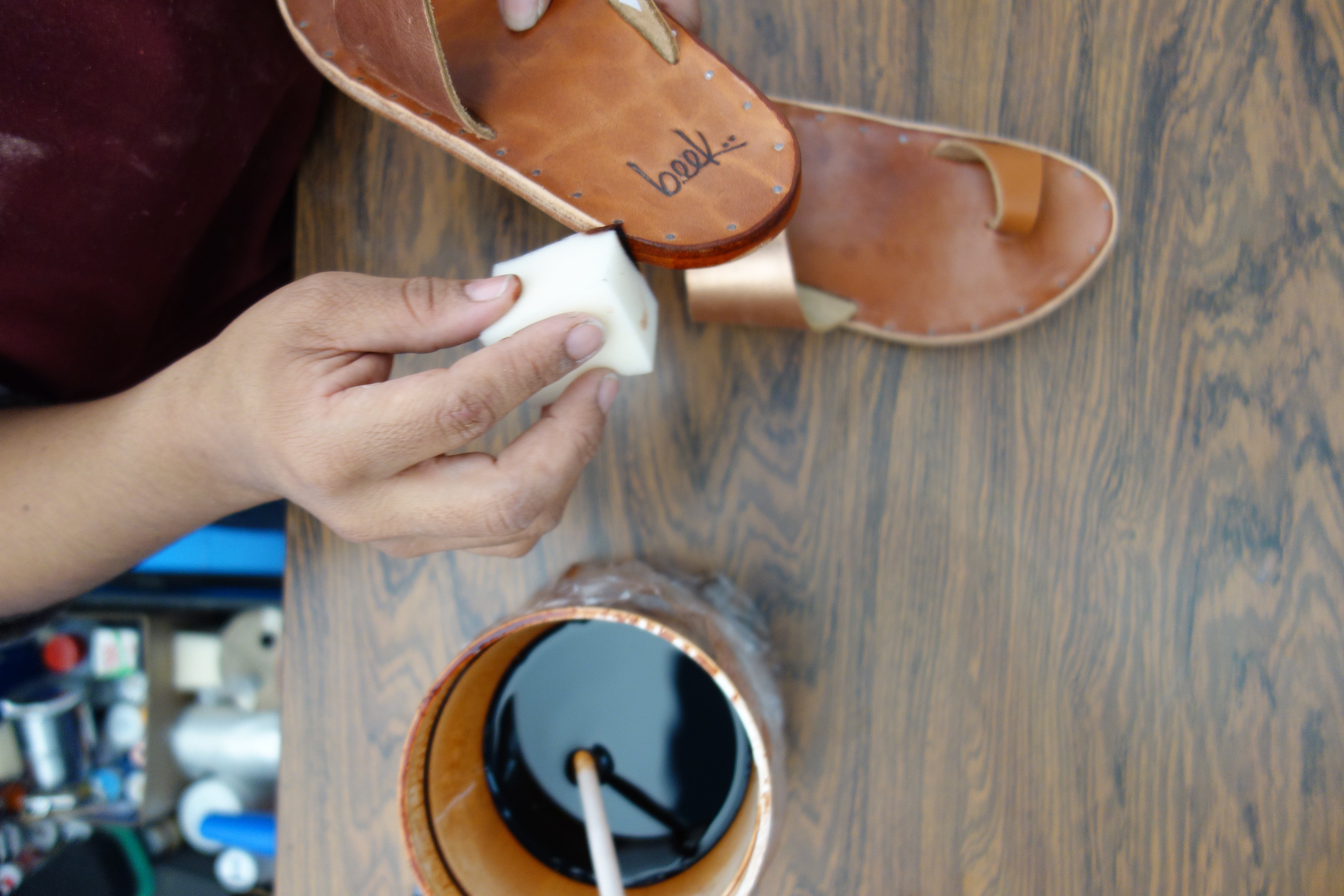 Factory worker hand dyeing Finch rose gold/tan sandals