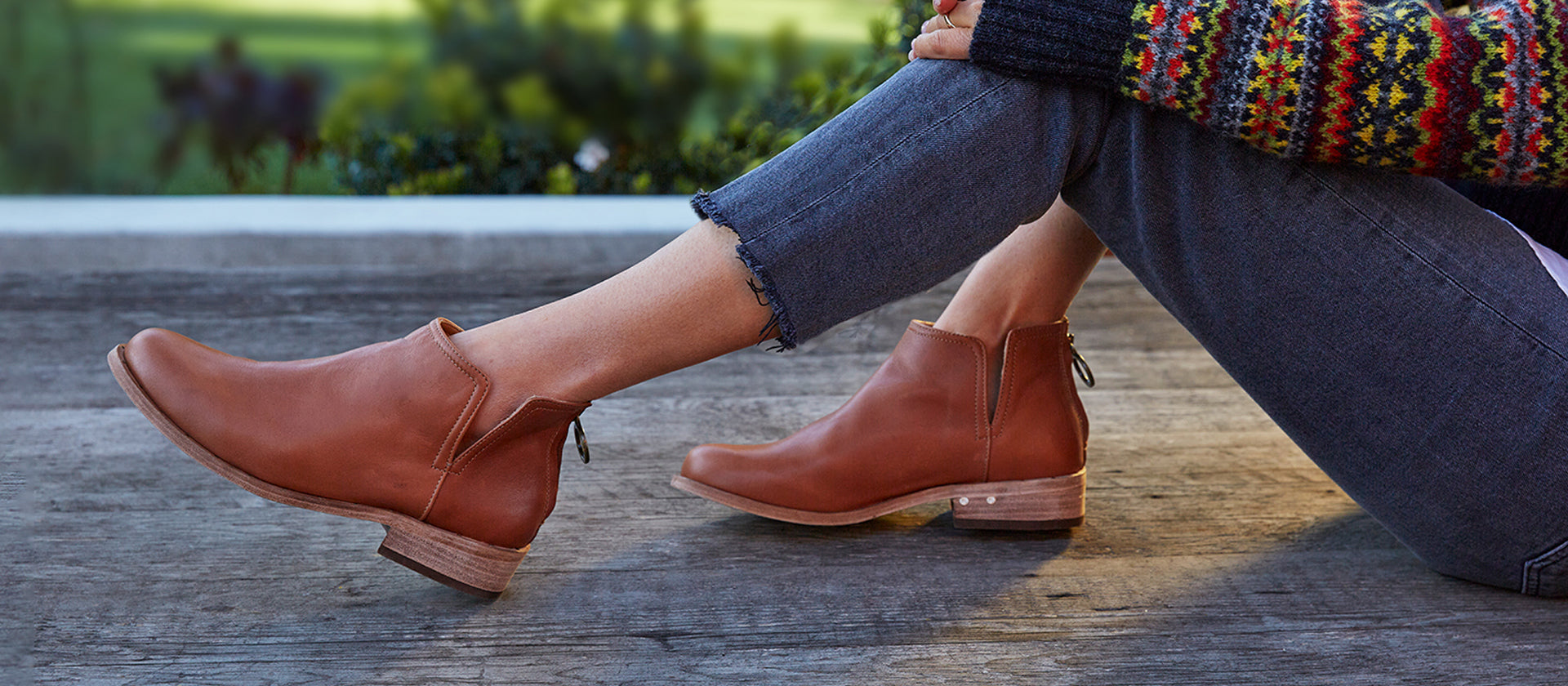 Woman wearing Falcon leather booties in cognac.