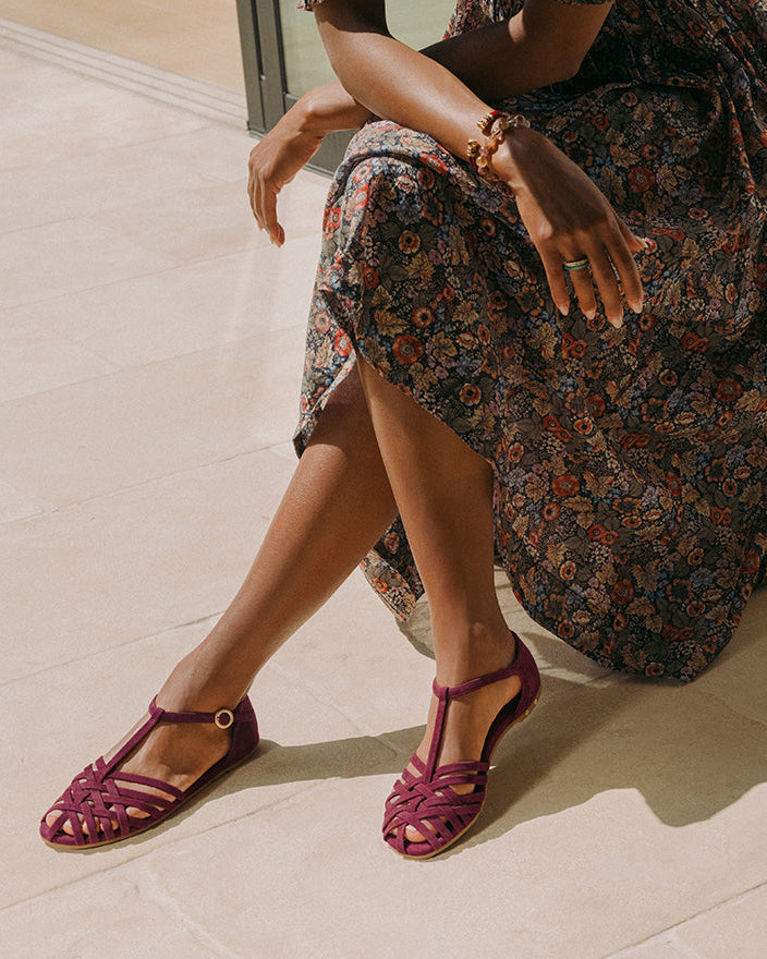 Woman wearing Wren suede basket woven ankle strap sandal in prune with floral dress