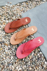 Group shot of Seabird Woven leather flip flop sandals in tan, honey, hibisucs.