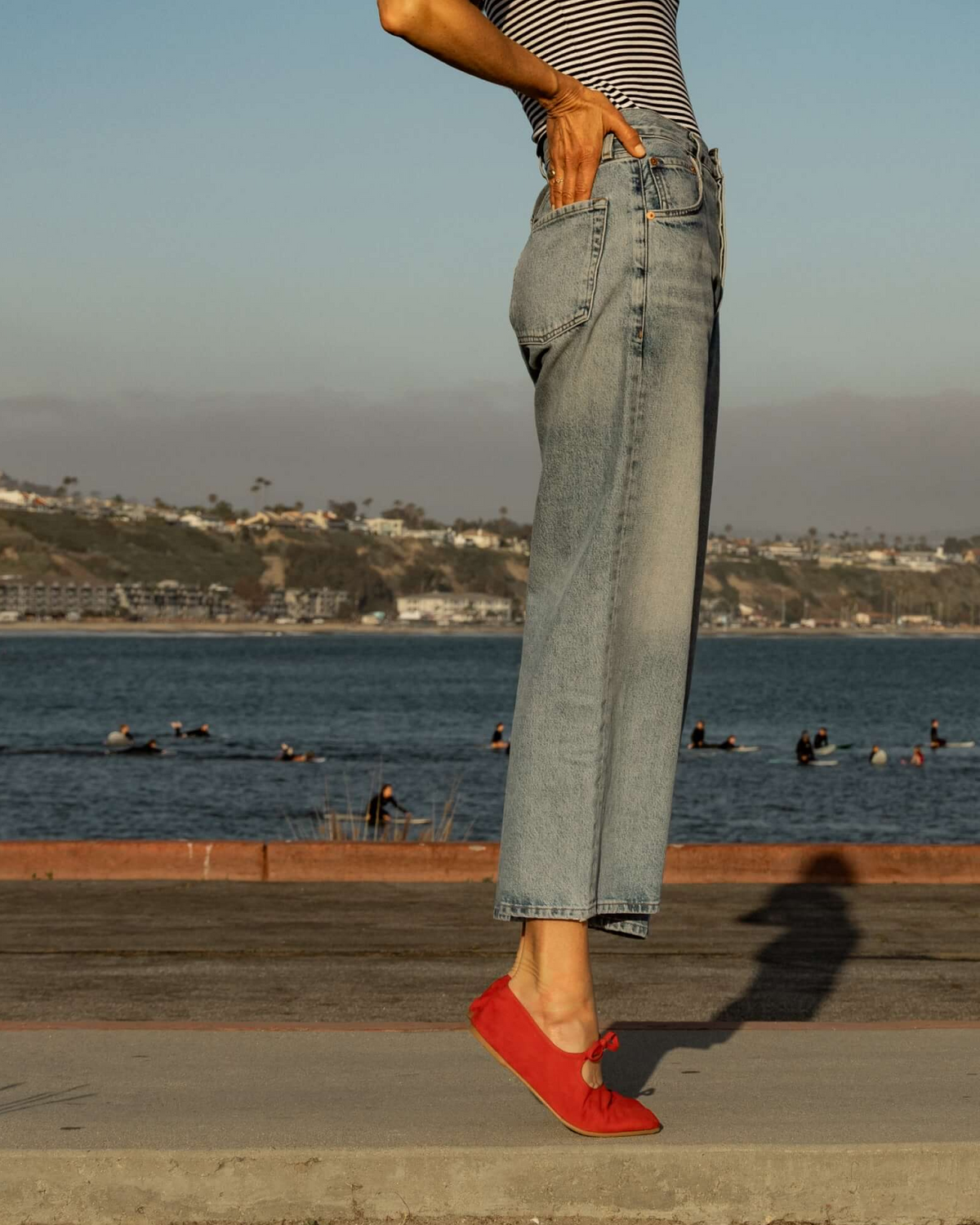 Abbie Crane wearing Crane Bow suede mary jane ballet flats in poppy with jeans and striped top