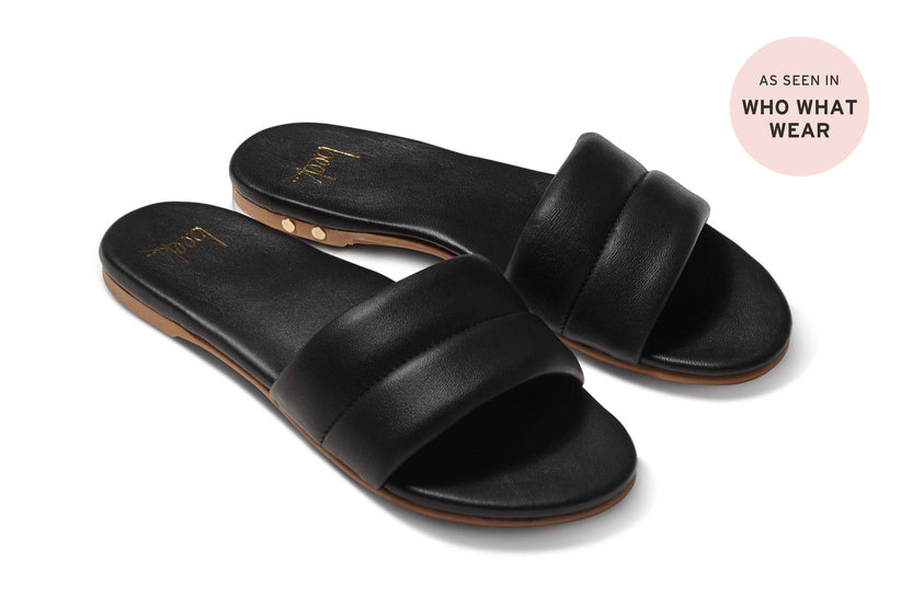 Sugarbird slide sandal - black - angle shot with press badge "as seen in Who What Wear"