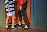 Women wearing Oriole and Albatross leather slide sandals in black.