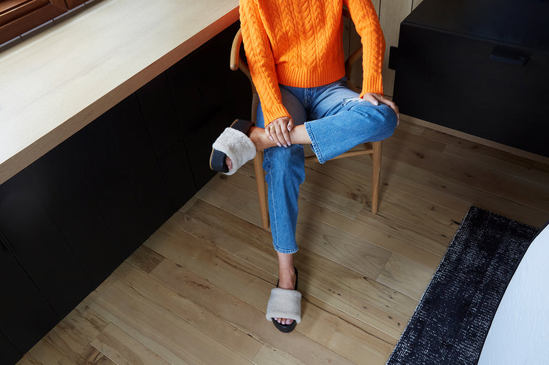Woman wearing Albatross Shearling platform sandal in natural/black