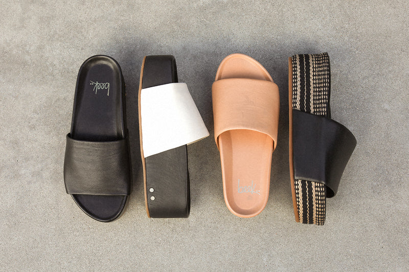 Group shot of Albatross leather platform slide sandal in black, eggshell/black, and beach and Albatross Textile leather platform slide sandal in black.