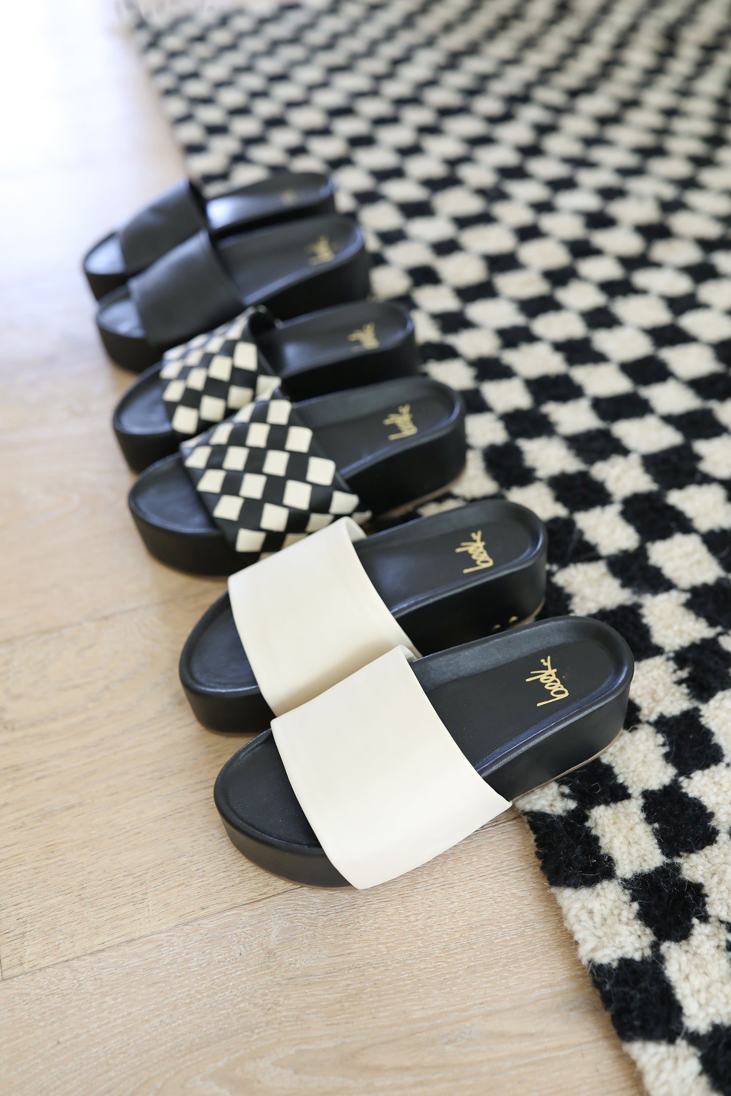 Group shot of Albatross in black, Albatross Woven in eggshell/black, Albatross in eggshell/black.