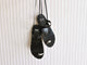 Amethyst Leather toe-ring ankle wrap sandal in black hanging on wall