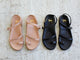 Group shot of Auklet leather toe-ring sandal in beach and black.