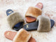 Group shot of Shearling slide sandal in bronze/black and honey/tan.