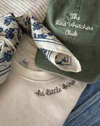 beek merch: pixie scarf in navy, bird watchers hat in fern, little bird sweatshirt in vintage white