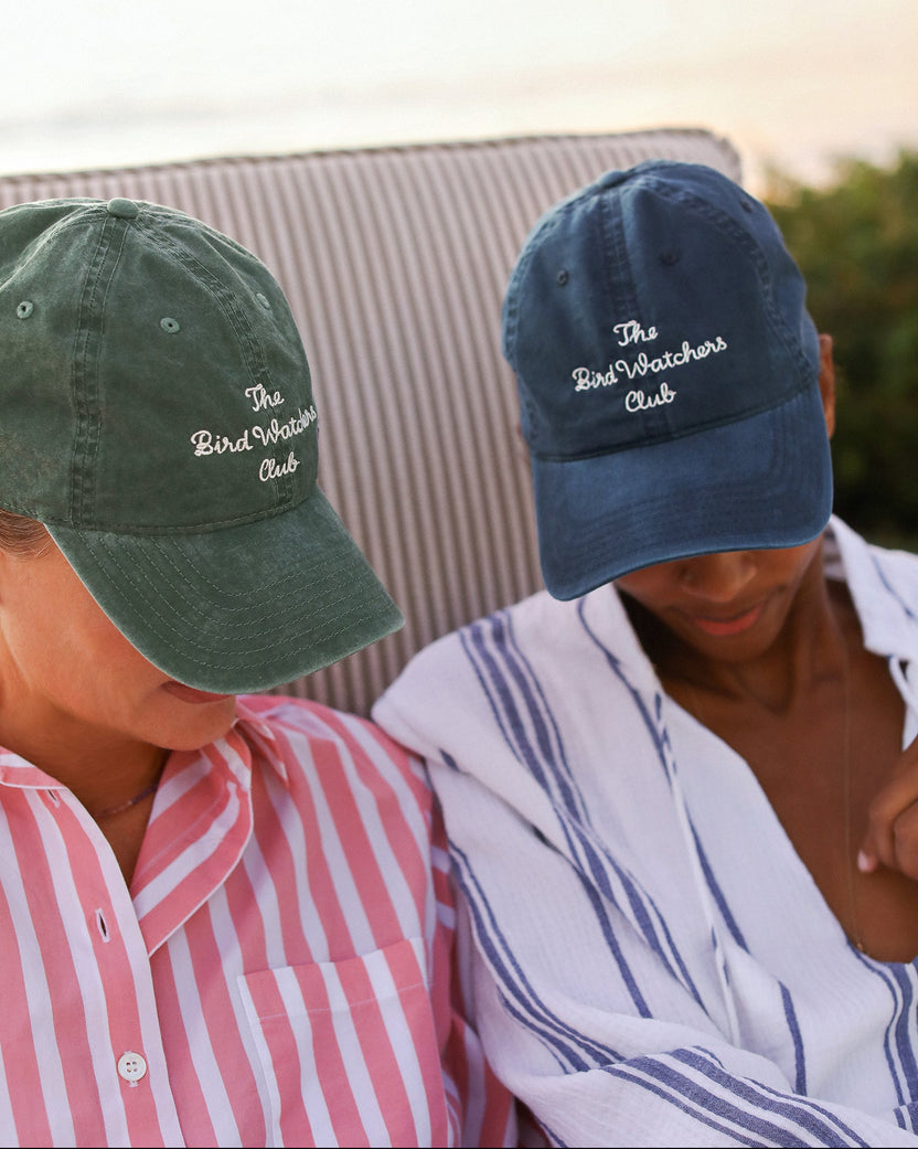 Women wearing bird watch hats in fern and navy