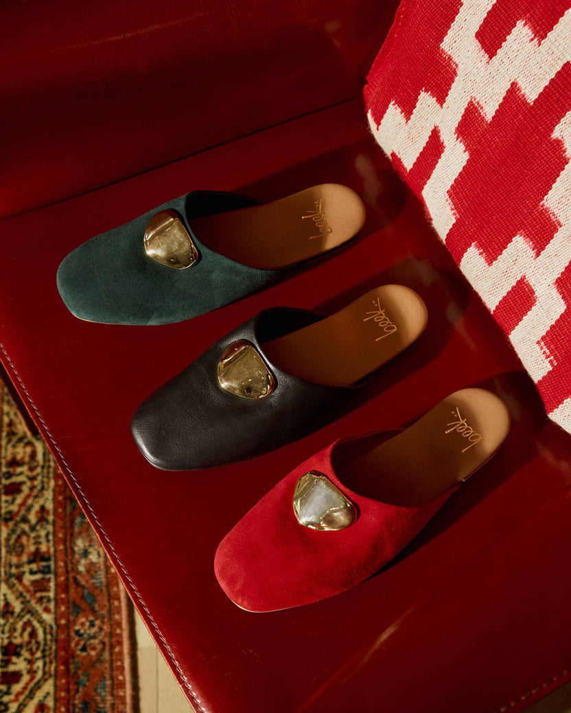 Group shot of Blackbird Bling suede mule with attached gold charm in crimson suede, black leather, teal suede