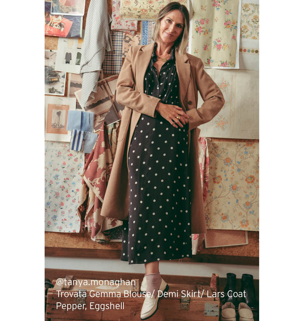 @tanya.moaghan wearing Trovata Gemma blouse, Demi skirt and Lars coat with beek Pepper leather loafers in eggshell.