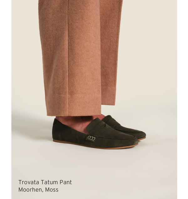 Woman wearing Trovata Tatum pants with beek Moorhen suede loafers in moss.