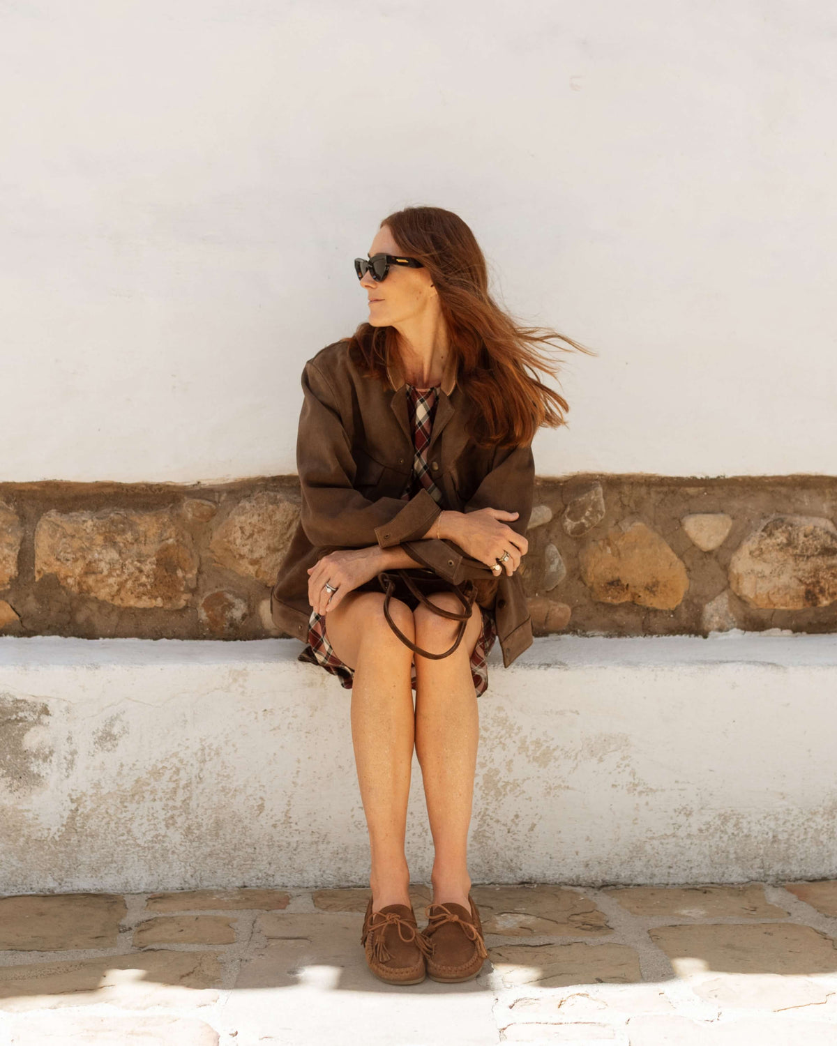Samantha Wennerstrom wearing Burke suede moccasin shoe in chestnut with plaid dress and coat