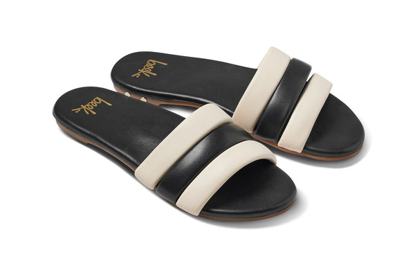 Calibird leather slide sandals in eggshell/black - angle shot