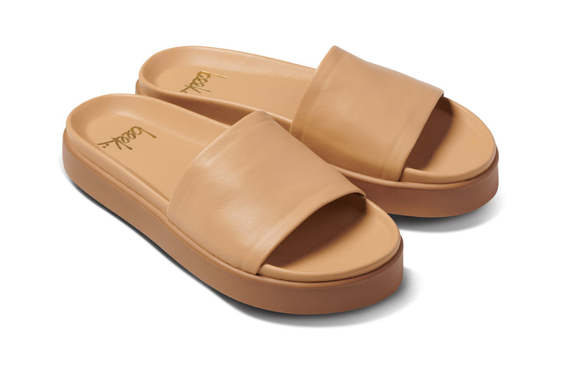 Chick leather platform slide sandals in beach - angle shot