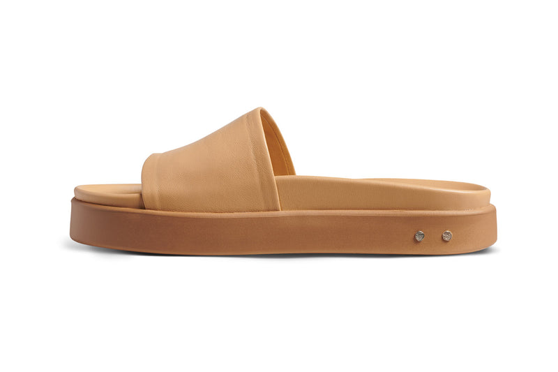 Chick leather platform slide sandals in beach - side shot