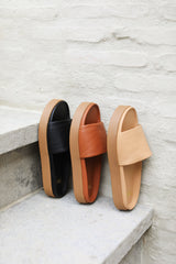 Chick leather platform slide sandals in black, tan, and beach.
