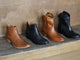 Group shot of Cowbird leather boots in tan and black with Condor leather boots in tan and black.