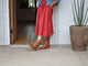 Woman wearing Condor leather boots in tan with red dress and jean jacket