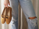 Woman carrying Crane suede mary jane shoe in caramel wearing distressed jeans
