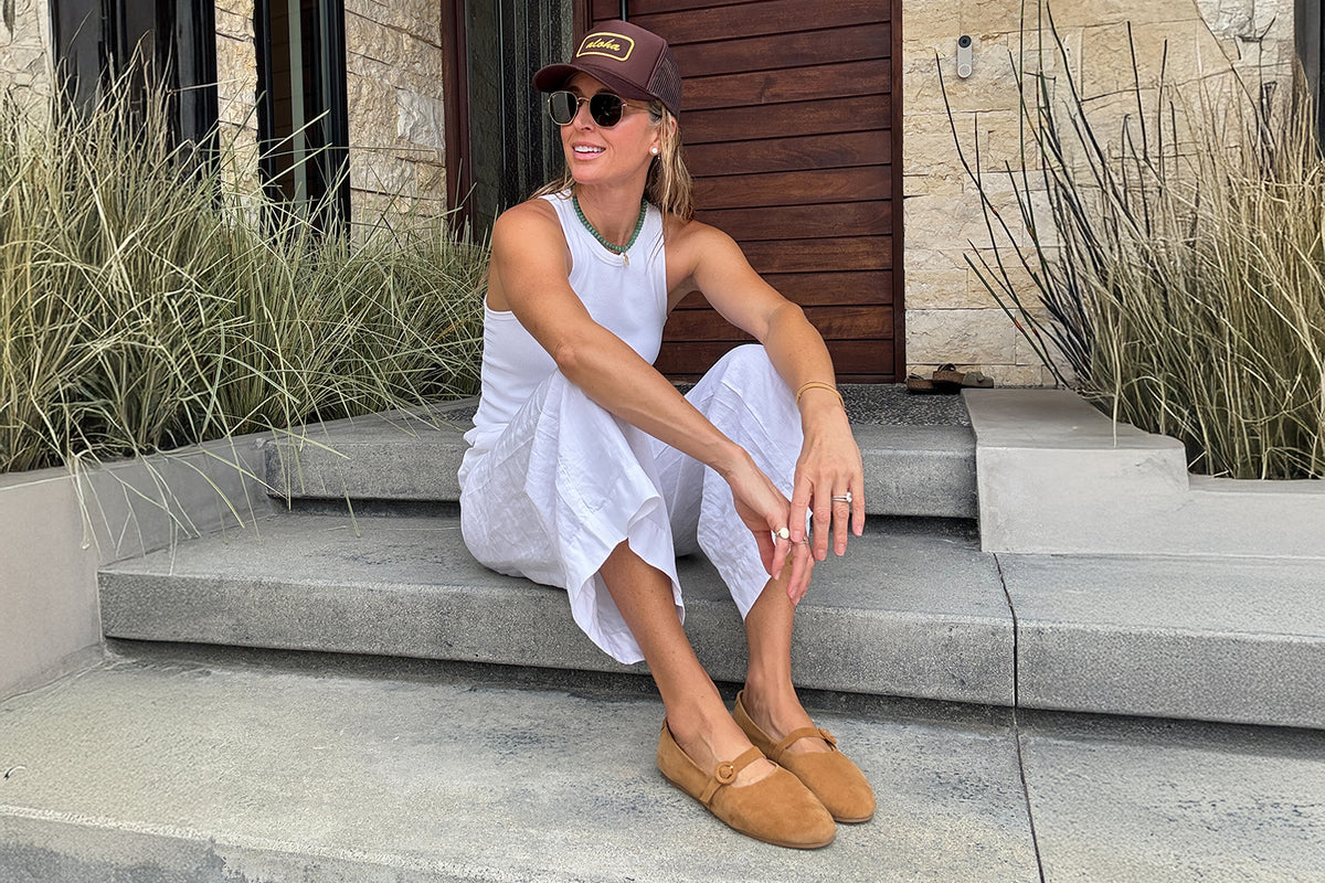 Abbie Crane @houseofabbie wearing Crane suede mary jane shoe in caramel with white pants and tank top.