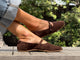 Woman wearing Crane suede mary jane shoe in coffee with jeans