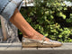 Woman wearing Crane leather mary jane shoes in gold with jeans.